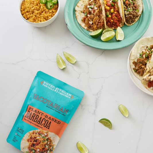 Tacos on a plate with a packet of taco seasoning on a white surface